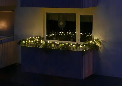 LED lights and spruce on a balcony