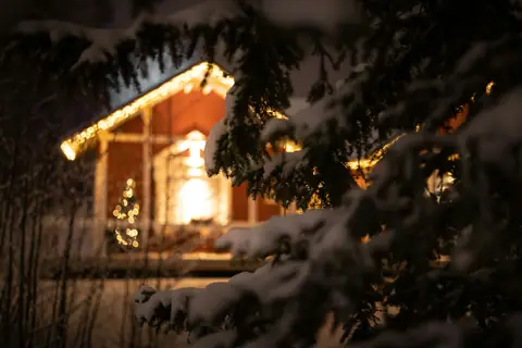 House lit up at night in the snow